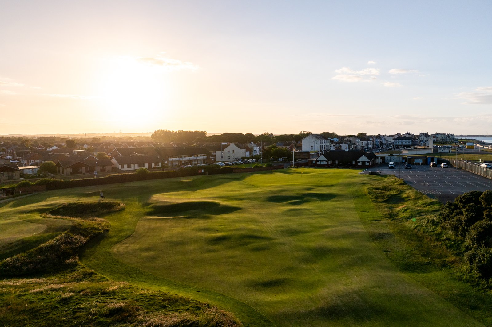 Seaton Carew Golf Club links course at sunset with the town and coast beyond